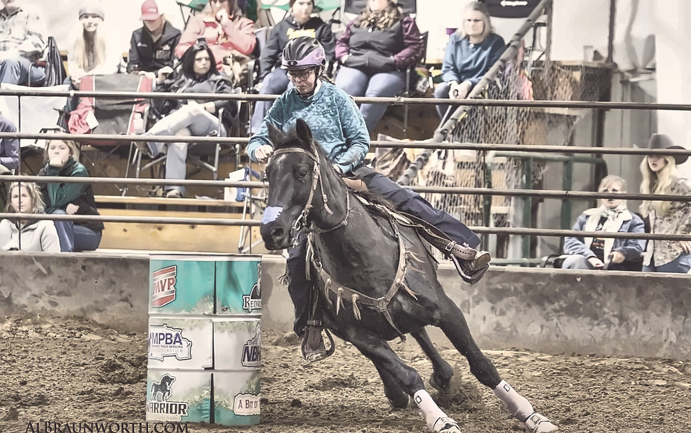 A barrel racer turning the first barrel at a PEWC-sanctioned event